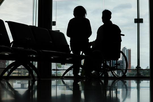 의대정원을 둘러싼 의정갈등이 이어지고 있는 가운데 21일 서울 한 대형병원에서 한 환자와 보호자가 창 밖을 바라보고 있다.  [연합뉴스]